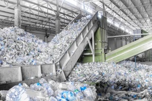 closeup escalator with a pile of plastic bottles at the factory for processing and recycling